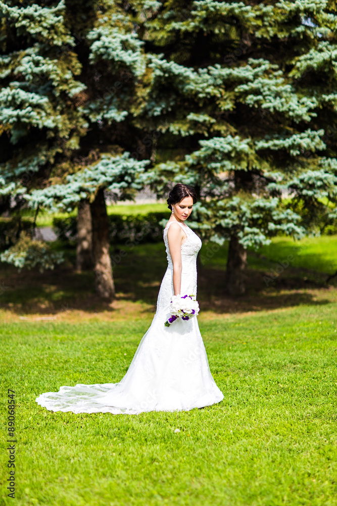 Beautiful bride in wedding dress and bridal bouquet