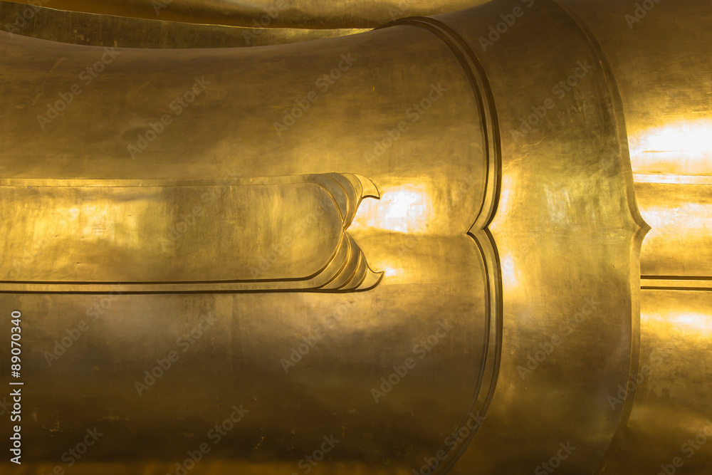 Thai art background on reclining buddha gold statue