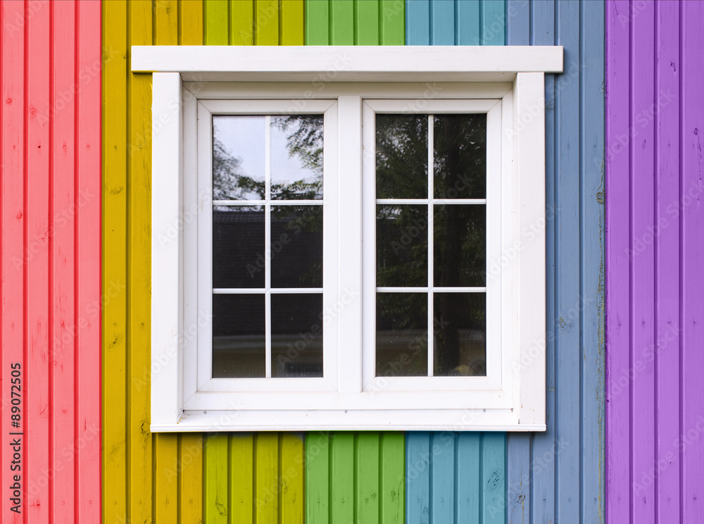 rainbow house. wooden wall of a house painted in a rainbow of colors rainbow house. wooden wall of a house painted in a rainbow of colors