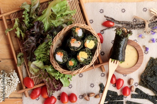 Vegetable salad wrapped with seaweed into spring rolls.