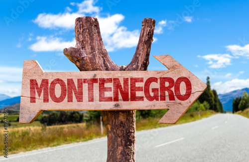 Montenegro wooden sign with road background photo