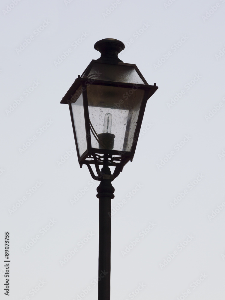 An ornate street lamp made of wrought iron.