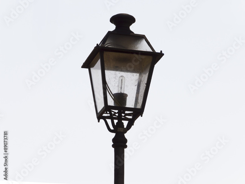 An ornate street lamp made of wrought iron. © alan_p