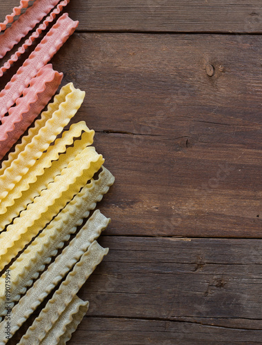 Tricolor mafalde pasta on the wood photo