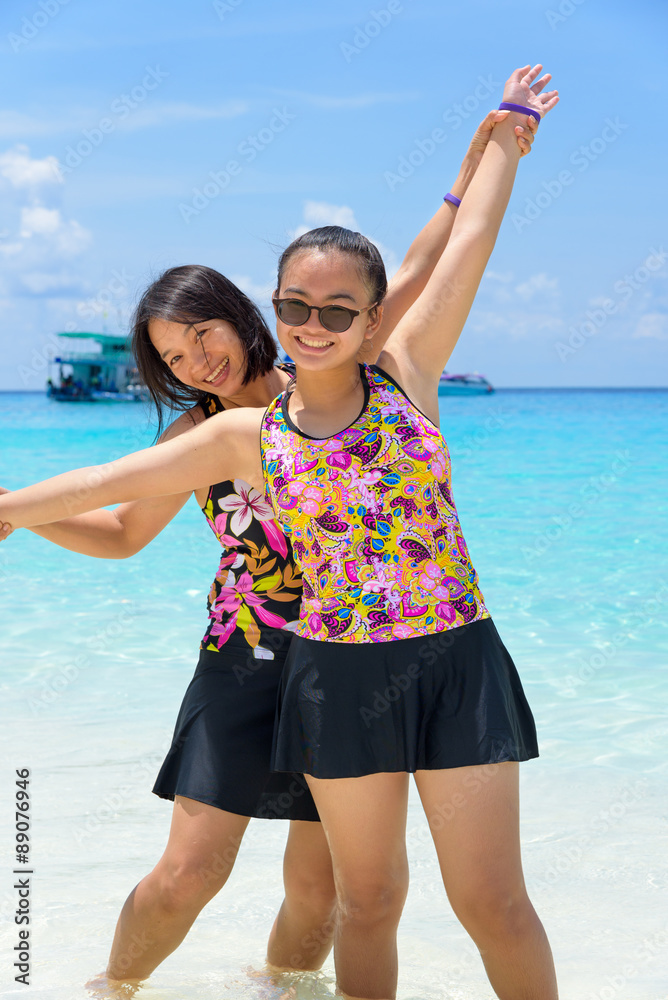 Mother and daughter on the beach at Similan islands, Thailand Mother and daughter on the beach at Similan islands, Thailand