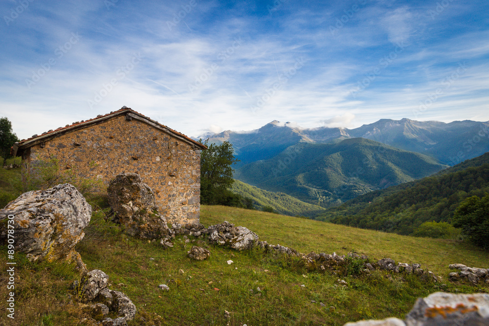 View of houses with tile roofs against mountains in the evening View of houses with tile roofs against mountains in the evening
