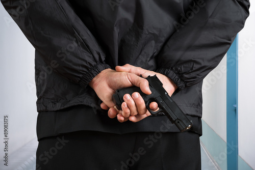 Close-up Of Bodyguard Holding Pistol