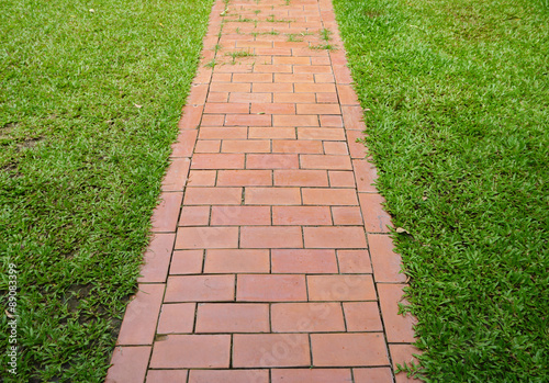 red brick walkway with green grass