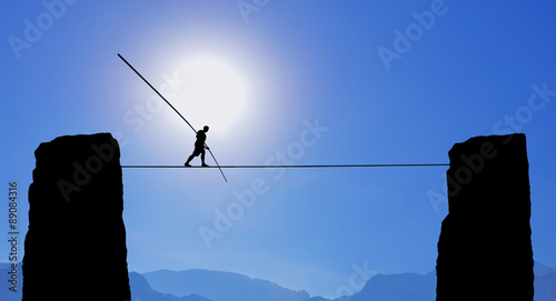 Tightrope Walker Balancing on the Rope photo