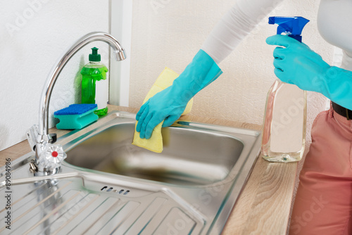 Woman Wiping Kitchen Sink