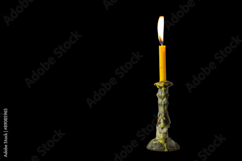 Light with candlestick on dark background