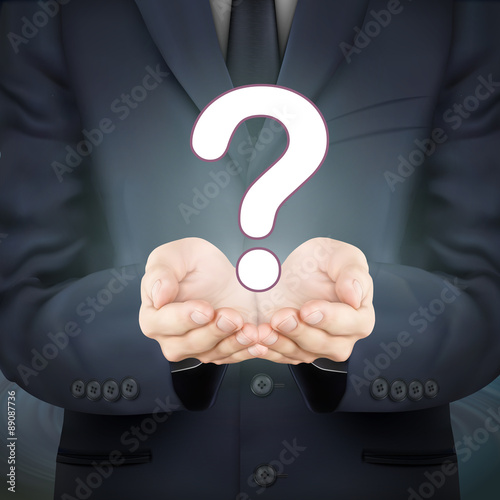 businessman holding question mark