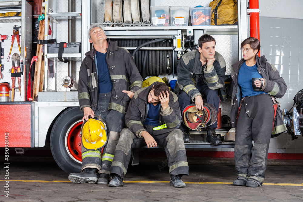 Fototapeta premium Team Of Tired Firefighters At Station