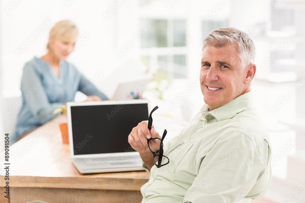 Smiling businessman looking at the camera Smiling businessman looking at the camera