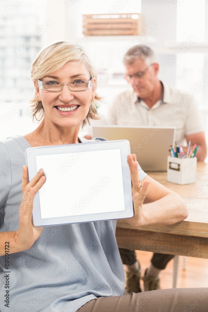 Smiling businesswoman showing her tablet Smiling businesswoman showing her tablet
