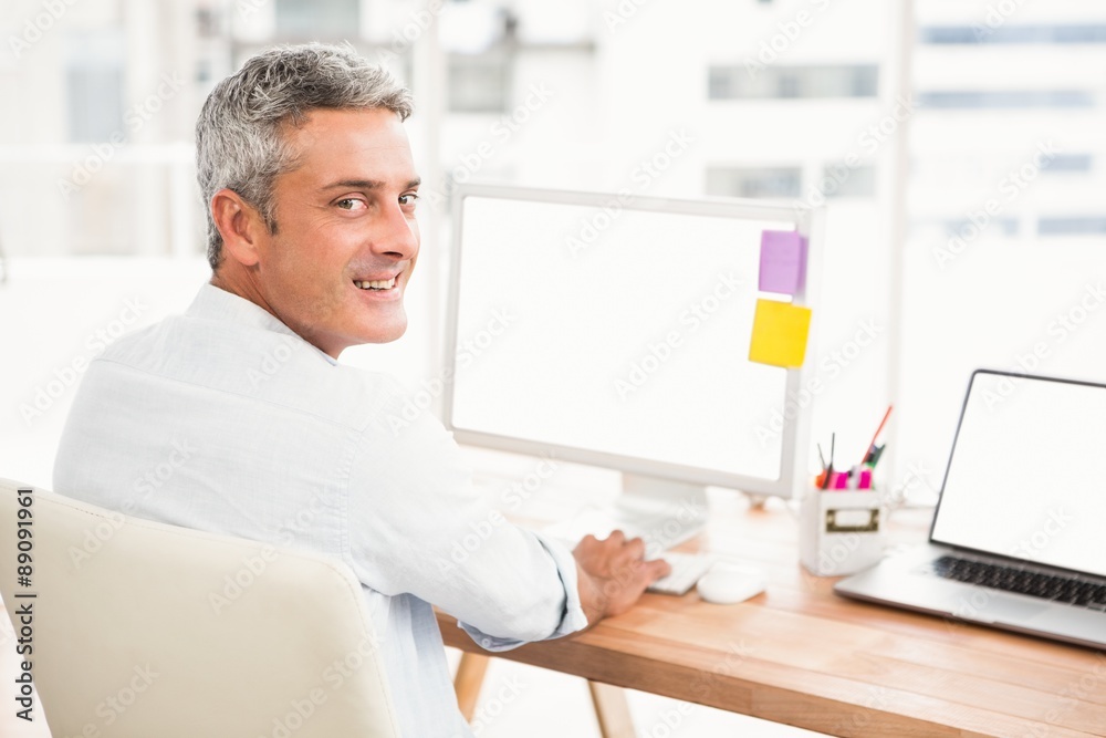 Smiling casual businessman working with computer Smiling casual businessman working with computer