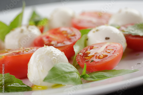 caprese salad with mini mozzarella balls and tomatoes