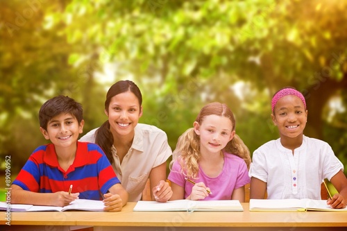 Composite image of pretty teacher helping pupils in library