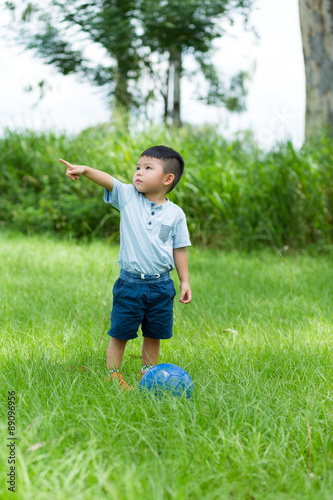 Little boy playing soccer at outdoor