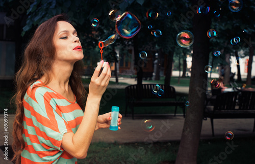 beautiful woman blowing bubbles