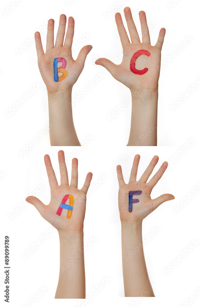 Alphabet (letters) painted on children hands. Rises up hands. Alphabet (letters) painted on children hands. Rises up hands.