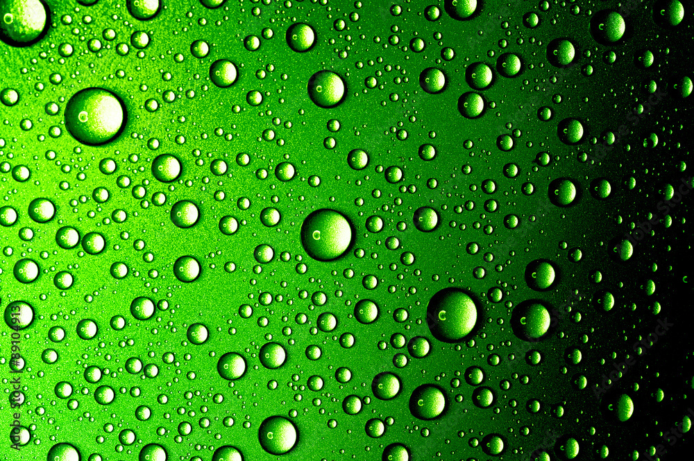 Water drops closeup. Abstract green background 