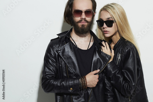 fashion beautiful couple in black leather wearing sunglasses