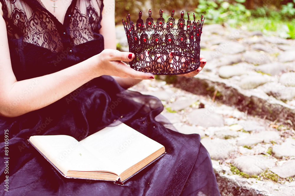 Toned picture with a sitting woman holds a book