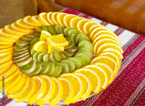 Obraz na płótnie Beautiful scenery of fruit with orange, lemon, kiwi on wooden background w salonie