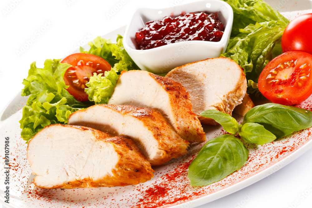 Roast chicken fillet and vegetables on white background Roast chicken fillet and vegetables on white background