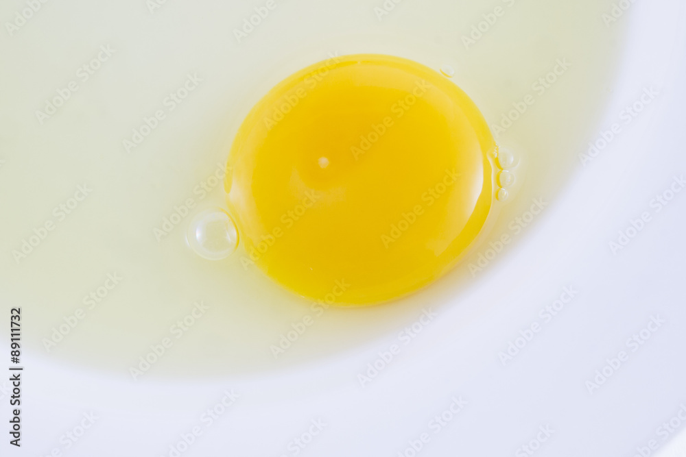 raw egg on white dish raw egg on white dish