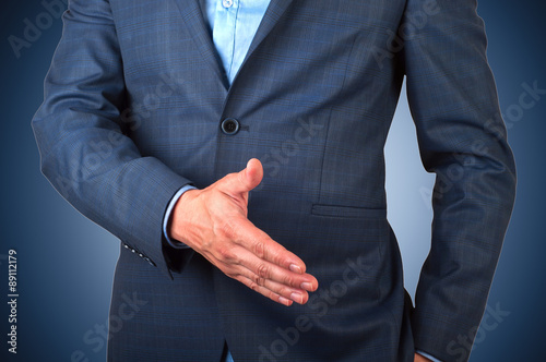 businessman extending hand to shake isolated
