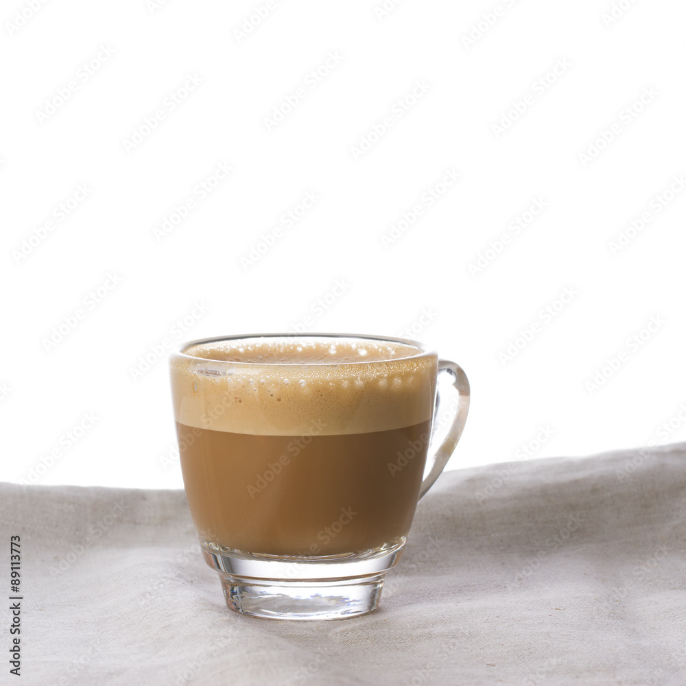 Cappuccino with crema in a transparent cup on sacking Cappuccino with crema in a transparent cup on sacking
