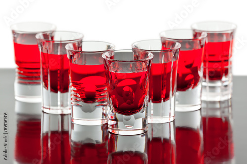 Beautiful shot crystal glasses with red liquid