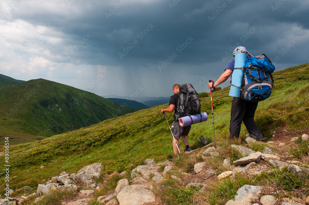 Fototapeta premium Group of tourists with large backpacks are on mountain