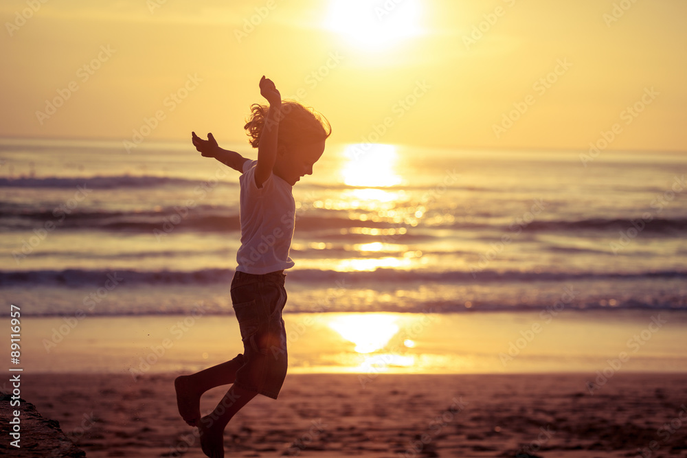 Happy little boy jumping on the beach Happy little boy jumping on the beach
