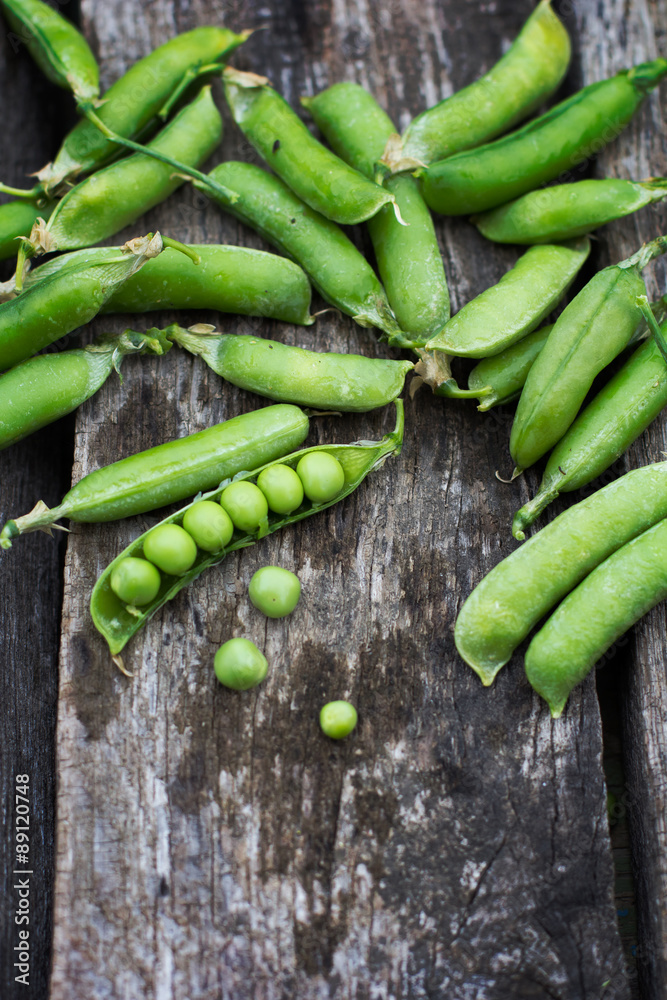 Young fresh green peas on wooden background Young fresh green peas on wooden background