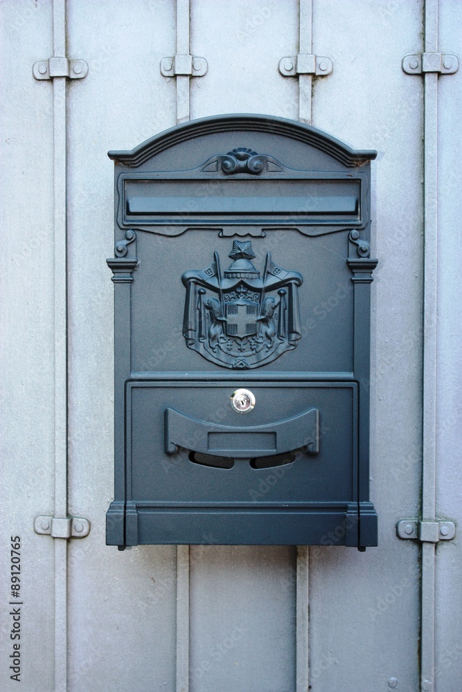 Mailbox on gray house wall