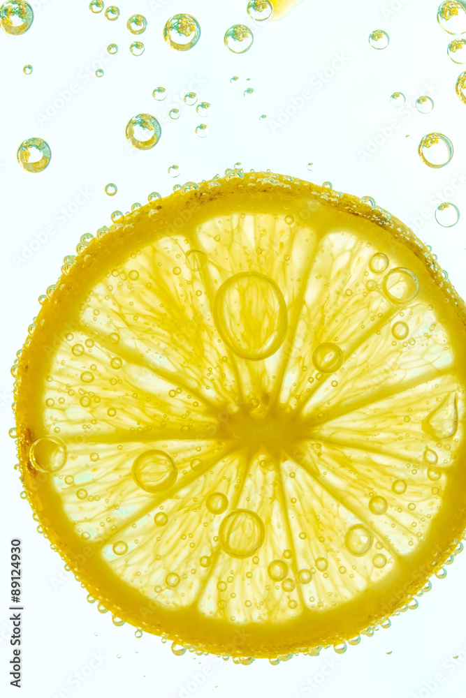 Fresh lemon slice in water with bubbles on white background Fresh lemon slice in water with bubbles on white background