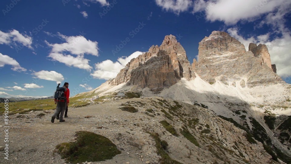 Tourists hiking in Dolomites Mountains, Italy Tourists hiking in Dolomites Mountains, Italy
