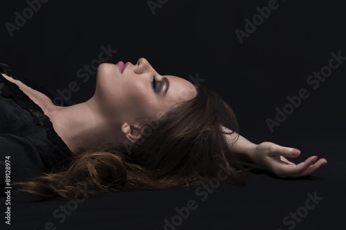 Fashion girl lying on black ground