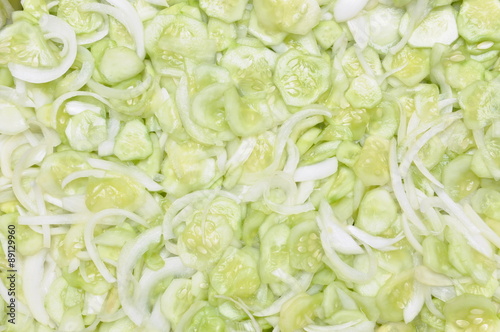 Sliced cucumbers and onions on salad