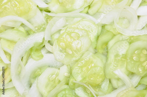 Sliced cucumbers and onions on salad