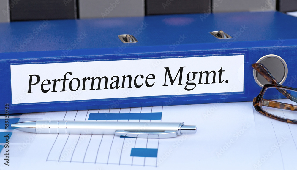 Performance Management - blue binder on desk in the office Performance Management - blue binder on desk in the office