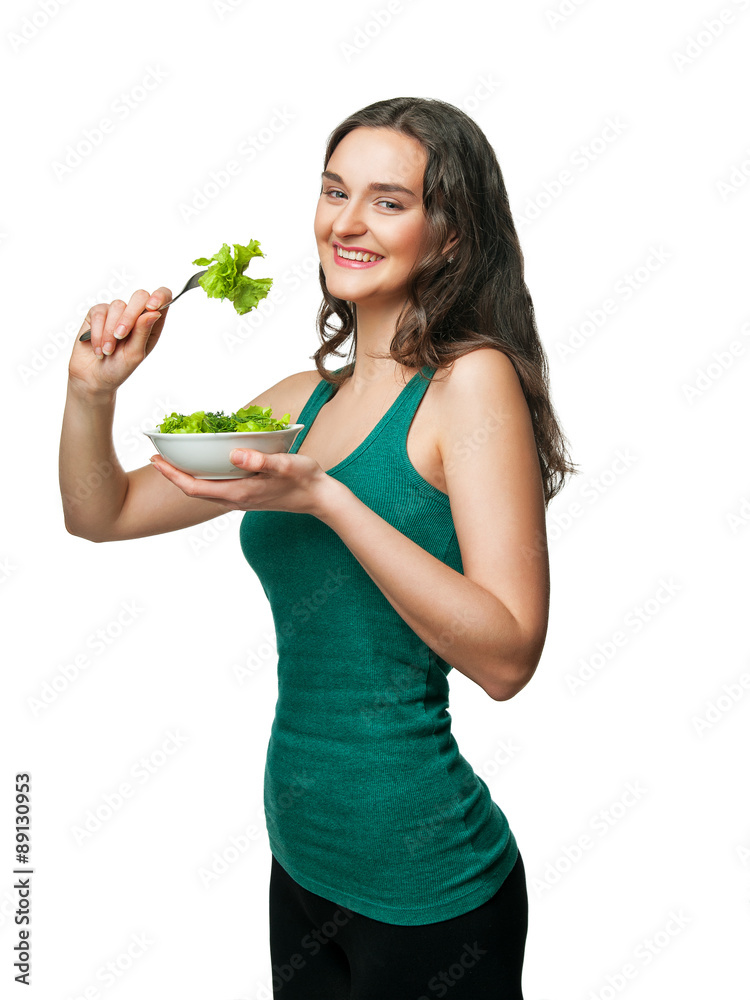 girl holding a plate and eating salad
