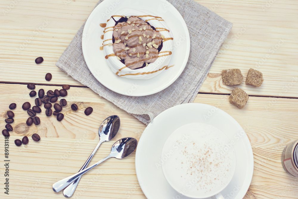 White meringues with brown chocolate stripes. Tonnet photo. White meringues with brown chocolate stripes. Tonnet photo.