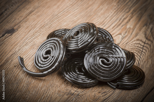 Licorice wheels candies close up on the wood photo