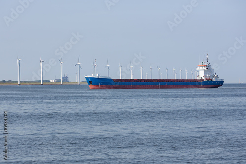 Dutch sea with cargo ship and wind turbines