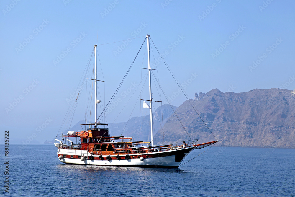 Old classic wooden sailboat in Santorini island, Greece Old classic wooden sailboat in Santorini island, Greece