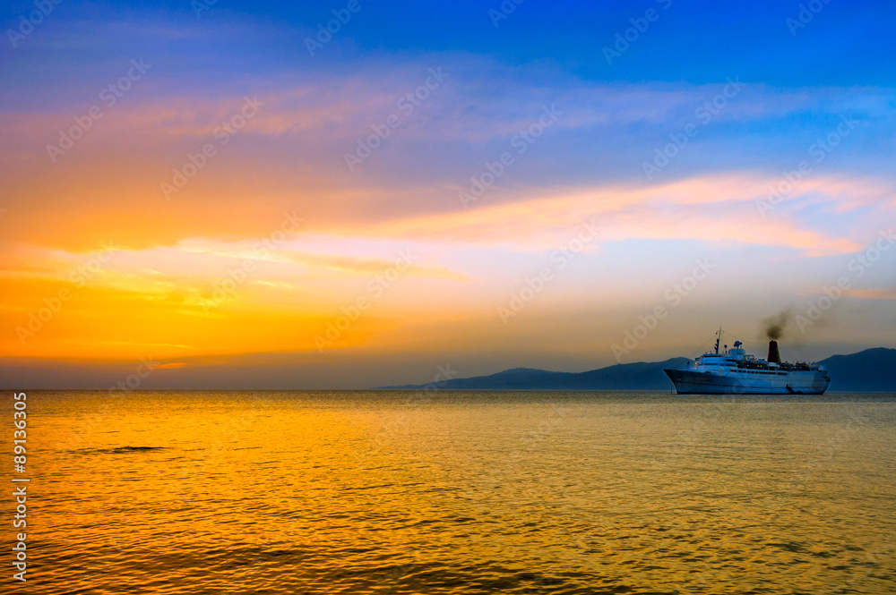 sunset on Aegean sea with cruise ship